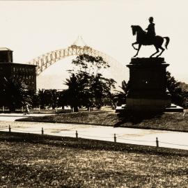 Sydney Harbour Bridge arch under construction from Botanic Gardens Sydney, 1930