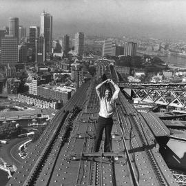 Brian Skien standing on top of the Sydney Harbour Bridge, circa 1980