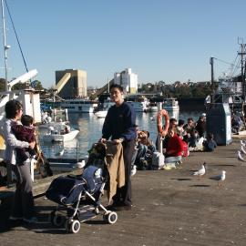 Fish Markets with groups of people sitting on the edge of the wharf, Bank Street Pyrmont, 2003
