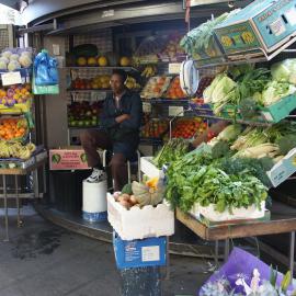 Fruit and vegetable stall, vendor sits on stool, Darlinghurst Road Potts Point, 2004