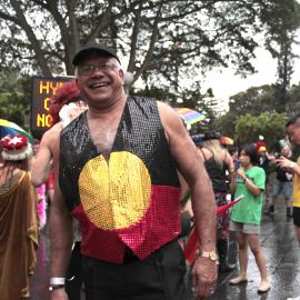Man in Aboriginal flag vest, Sydney Gay and Lesbian Mardi Gras (SGLMG), Hyde Park Sydney, 2012