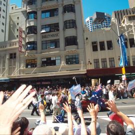 Waving hands as the Olympic Athletes Tickertape Parade passes by at George Street, Sydney, 2000