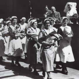 Parade of nurses carrying newborn babies, Crown Street Sydney, no date
